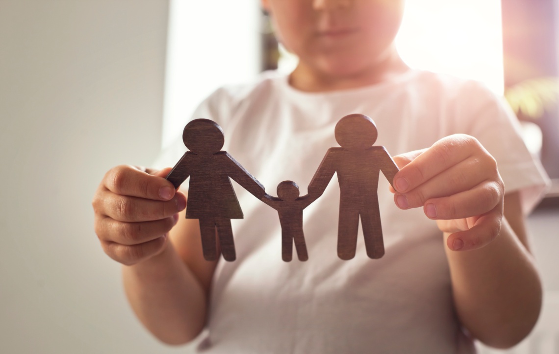 little-child-looking-wooden-figures-mom-dad-child-his-hands-concept-child-dreaming-about-family